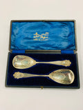 Pair of ornate silver plated serving spoons